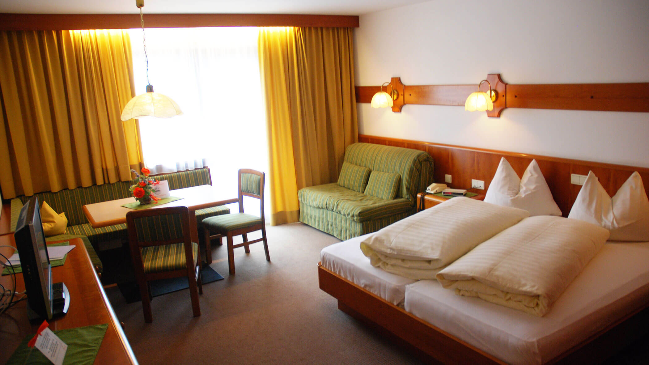 Residence Bacher in Olang - Wohnraum und Bett - 5 Sterne Hotel Mirabell Dolomites in Olang